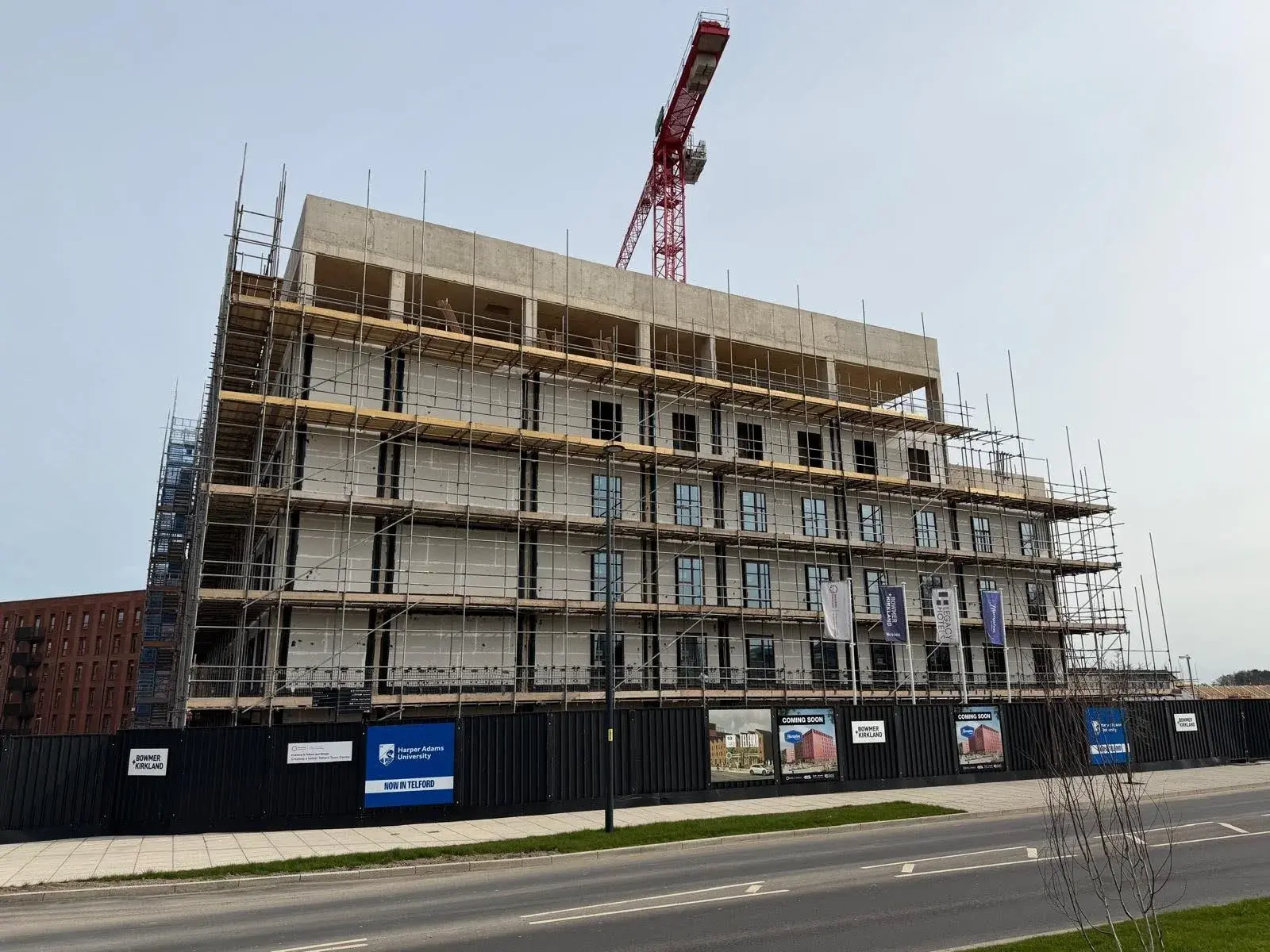 A high-rise building which has been stripped of its façade, and where contractors are comparing the different types of cladding systems available to them before moving on. 