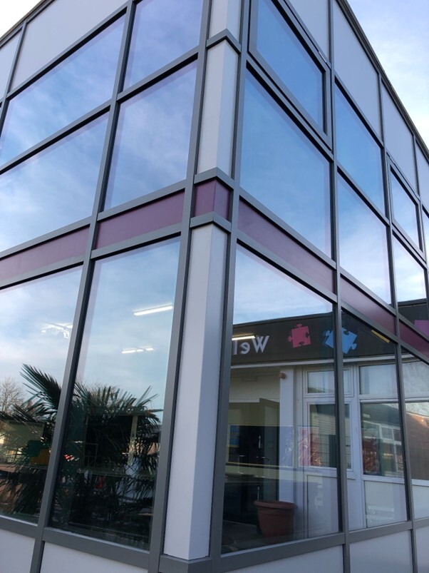 A curtain is being used instead of structural glazing for this commercial project, after weighing the pros and cons. 